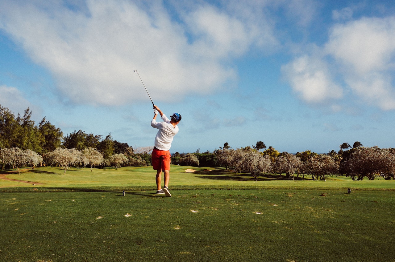 Guy playing golf in a country club