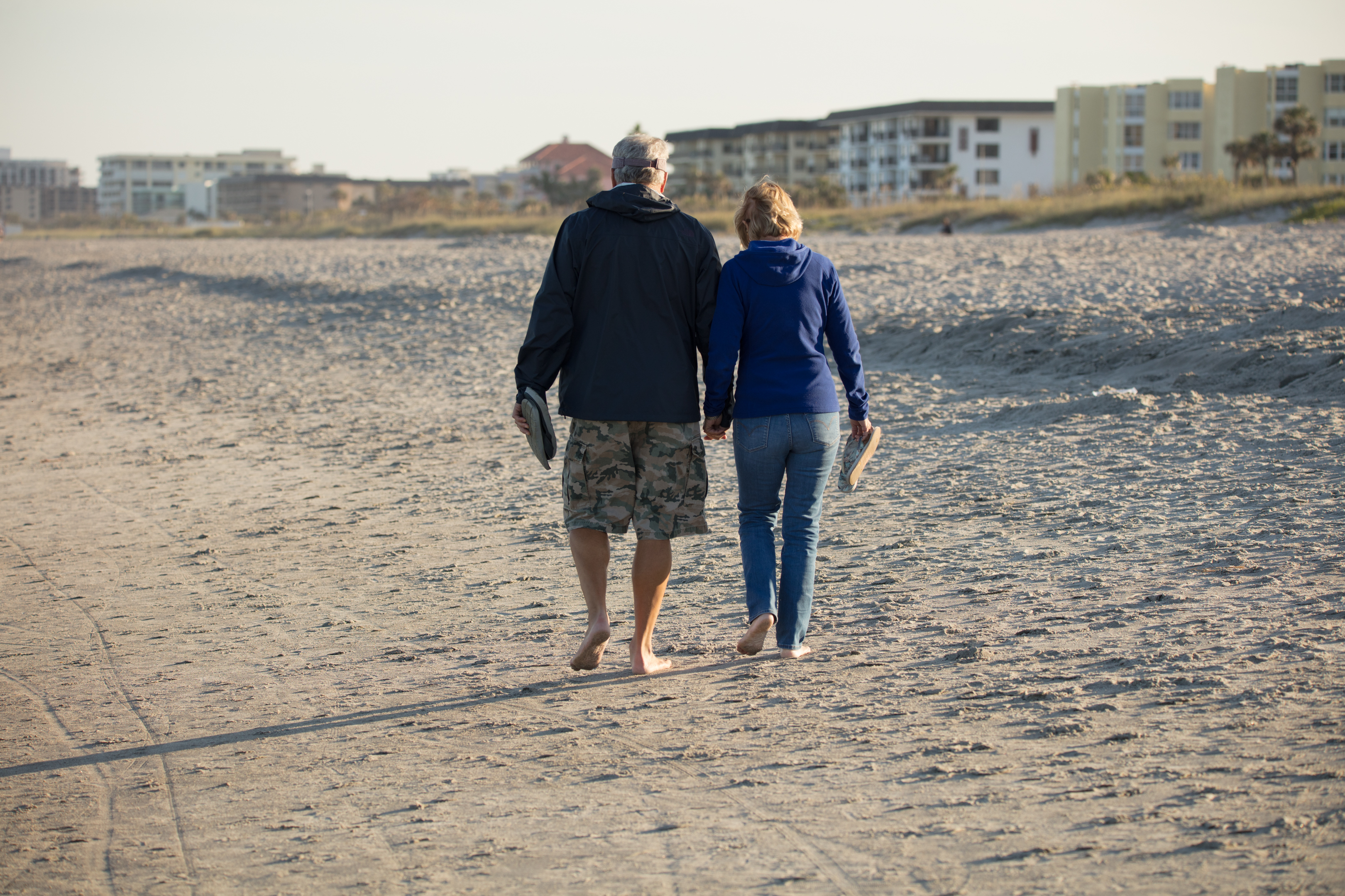 Older couple walking along beach