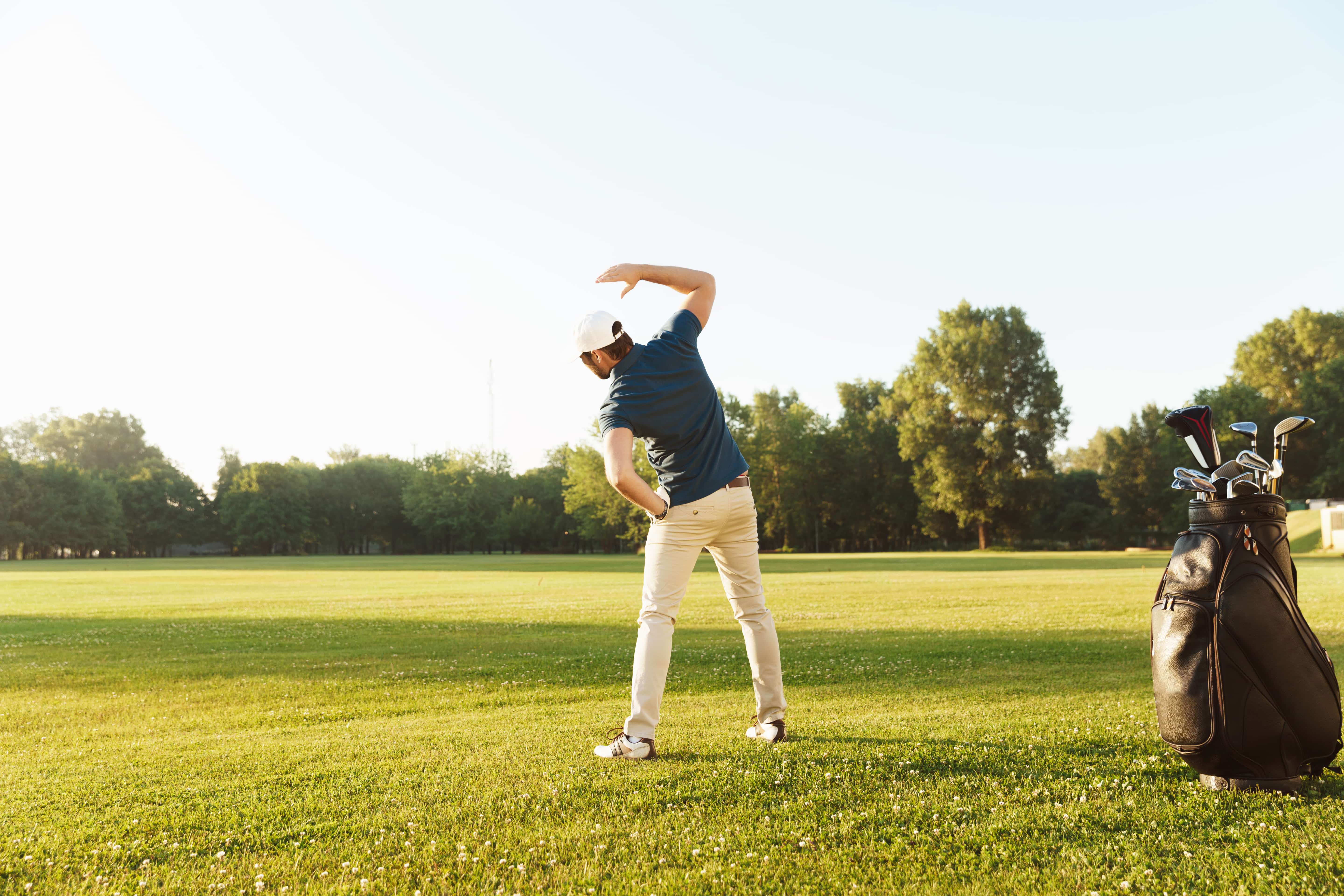 Man stretching before playing golf