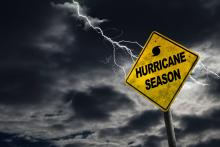 Bolt of lightning behind a sign that says hurricane season